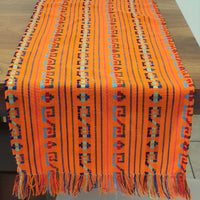 Colorful woven textile with patterns on a wooden surface