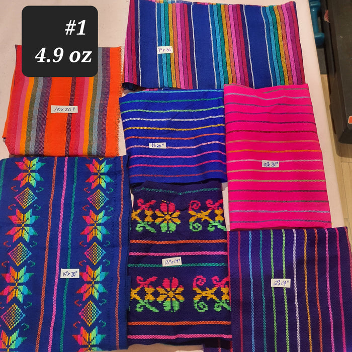 Colorful fabric samples with patterns and text labels on a flat surface