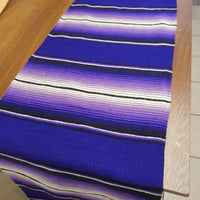 Close-up of a blue striped fabric on a wooden surface