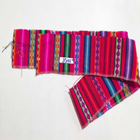 Colorful woven fabric with a visible brand label on a white background