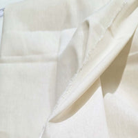 Close-up of beige fabric with a subtle pattern