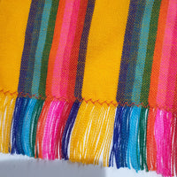 Close-up of colorful fabric with striped pattern on a yellow background