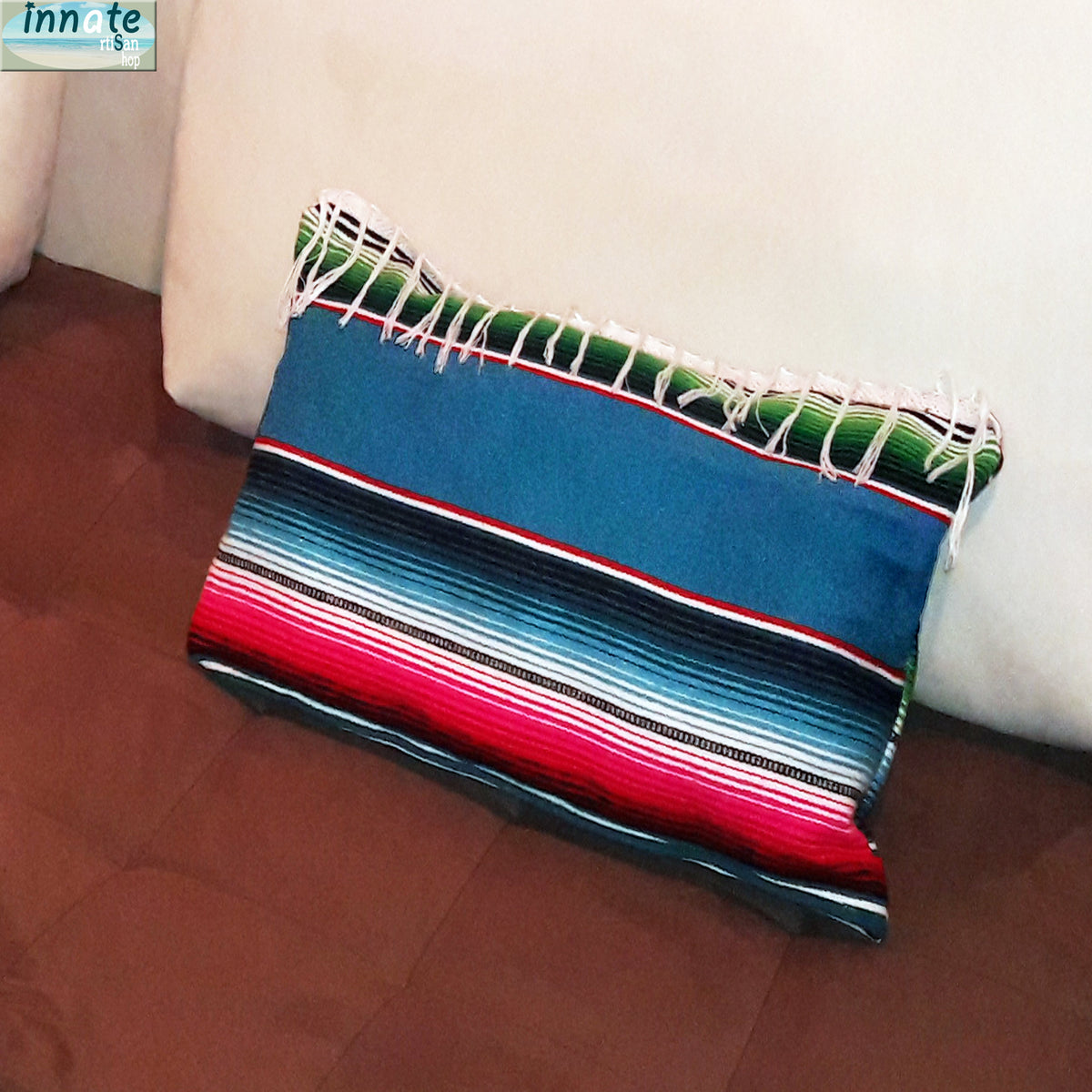 Colorful striped blanket draped over a white couch