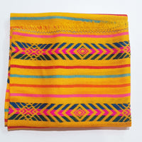 Colorful woven fabric with geometric patterns on a white background
