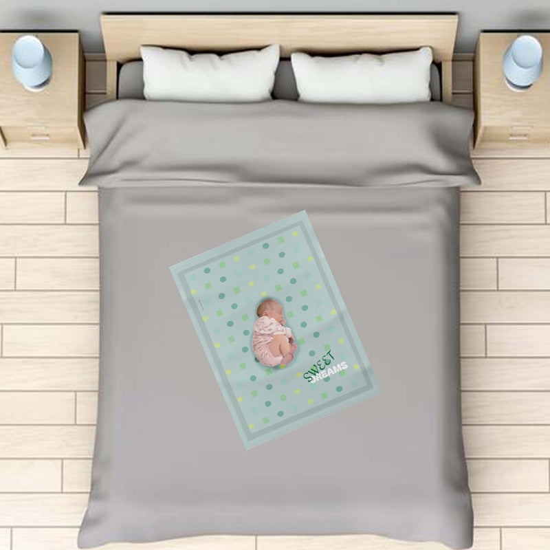 baby blanket, personalized, over a full size bed with a newborn on top