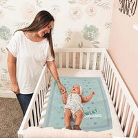 baby blanket, personalized, on a crib with a toddler and a woman