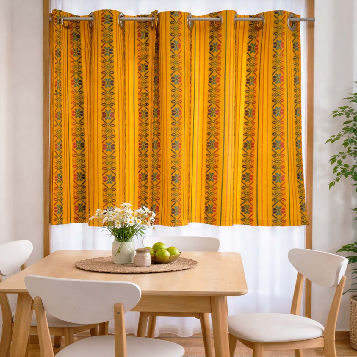 Dining room with a yellow patterned curtain, table, and chairs.