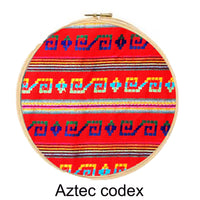 Embroidery hoop with Aztec codex pattern on a red background