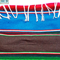 Colorful woven fabric with red, blue, green, and white stripes on a white background.