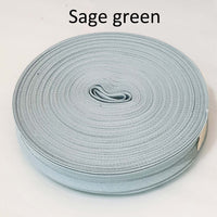 Sage green ribbon roll on a white background
