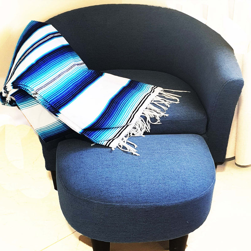 serape blanket, white, blue, over a blue sofa