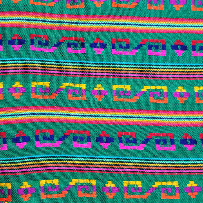 Colorful fabric with geometric pattern on a green background