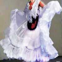 Person wearing a white dress with ruffles and lace details.