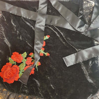 Black fabric with red floral embroidery and gray satin ribbon