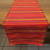 Vivid orange striped fabric on a wooden surface